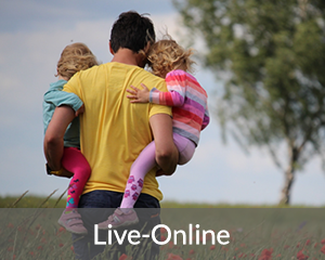 A man carries two young children, one on each hip, while walking in a field outside; the words "Live-Online" are at the bottom of the im
