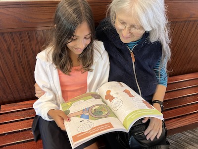 Anjali and her grandma looking at the book